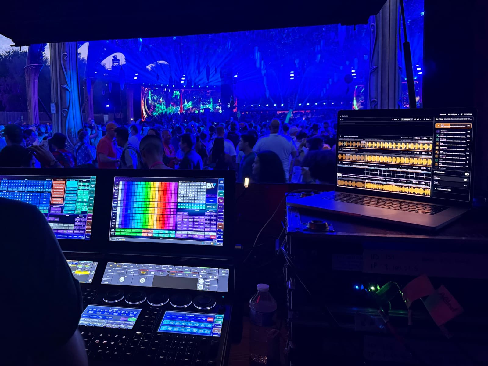 Lighting operator using Time-line Live beside a lighting console during a live DJ set at Tomorrowland